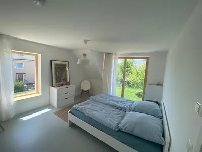 Ein Bett oder Betten in einem Zimmer der Unterkunft Das Lavendelhaus Weißenstadt Unser modernes und gemütliches Ferienhaus im Fichtelgebirge