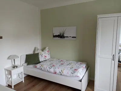 Ein Bett oder Betten in einem Zimmer der Unterkunft Große helle Ferienwohnung mit Balkon, ruhig gelegen mit guter Verkehrsanbindung