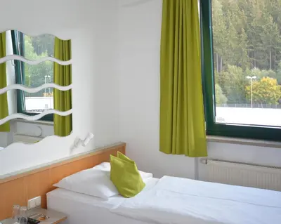 Ein Bett oder Betten in einem Zimmer der Unterkunft Motel Hirschberg