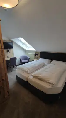 Ein Bett oder Betten in einem Zimmer der Unterkunft Landgasthof Thiem