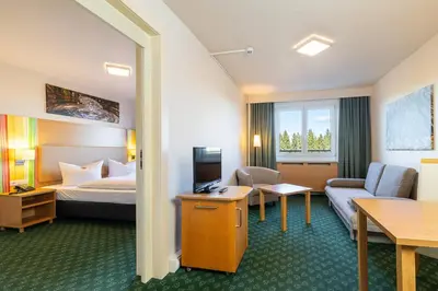 Ein Bett oder Betten in einem Zimmer der Unterkunft Hotel Am Bühl