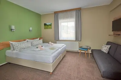 Ein Bett oder Betten in einem Zimmer der Unterkunft Gasthaus Stollmühle