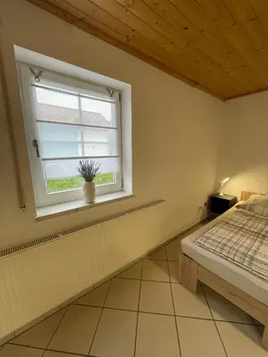 Ein Bett oder Betten in einem Zimmer der Unterkunft Ferienwohnungen Schiffmann