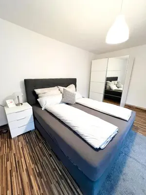 Ein Bett oder Betten in einem Zimmer der Unterkunft Zentrale Ferienunterkunft