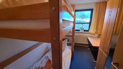 Ein Bett oder Betten in einem Zimmer der Unterkunft Ferienwohnungen Am Bühlwald