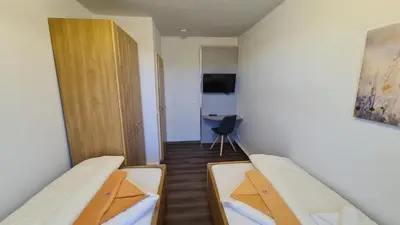 Ein Bett oder Betten in einem Zimmer der Unterkunft Ferienwohnungen Am Bühlwald