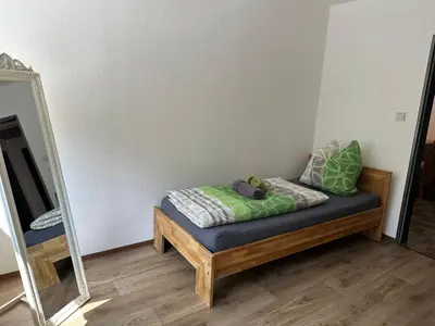 Ein Bett oder Betten in einem Zimmer der Unterkunft Ferienwohnung am Rosenbach