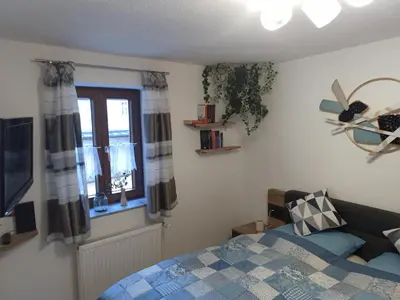 Ein Bett oder Betten in einem Zimmer der Unterkunft Ferienwohnung am Schloßbrunnen