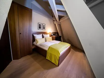 Ein Bett oder Betten in einem Zimmer der Unterkunft HotelBurg Falkenberg