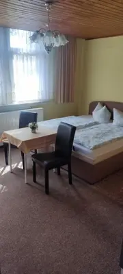 Ein Bett oder Betten in einem Zimmer der Unterkunft Pension Fischer Alte Windmühle