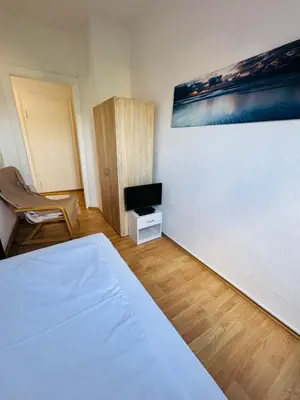 Ein Bett oder Betten in einem Zimmer der Unterkunft Das Siegener Familien-Residenz