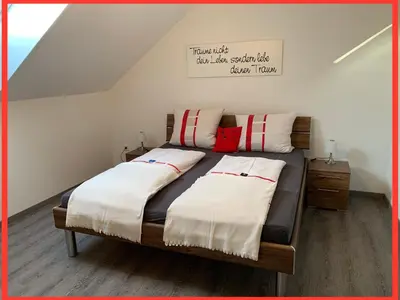 Ein Bett oder Betten in einem Zimmer der Unterkunft Husky-Hof