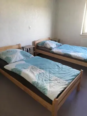 Ein Bett oder Betten in einem Zimmer der Unterkunft Wohnung für Arbeiter und Monteure bis 7 Personen
