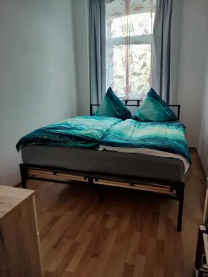 Ein Bett oder Betten in einem Zimmer der Unterkunft Ferienwohnung Lengenfeld