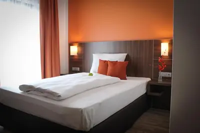 Ein Bett oder Betten in einem Zimmer der Unterkunft Hotel Rosenhof Garni