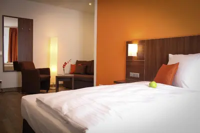 Ein Bett oder Betten in einem Zimmer der Unterkunft Hotel Rosenhof Garni