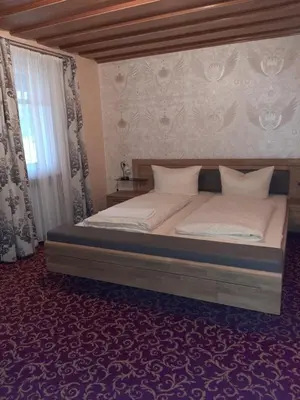 Ein Bett oder Betten in einem Zimmer der Unterkunft Landhotel Fuchsbau