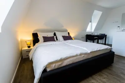 Ein Bett oder Betten in einem Zimmer der Unterkunft Apartmenthaus Königsallee