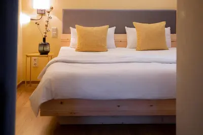 Ein Bett oder Betten in einem Zimmer der Unterkunft Posthotel Alexander Herrmann