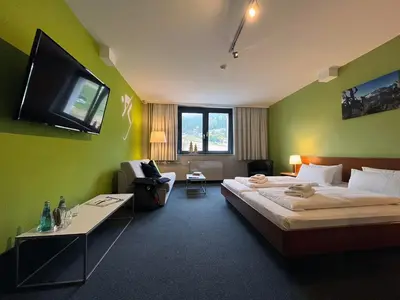 Ein Bett oder Betten in einem Zimmer der Unterkunft k1 sporthotel - Bike & Ski inklusive Hotel