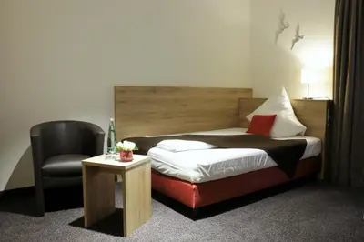 Ein Bett oder Betten in einem Zimmer der Unterkunft Hotel WITT am See