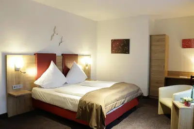 Ein Bett oder Betten in einem Zimmer der Unterkunft Hotel WITT am See