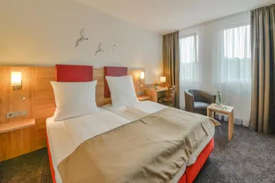Ein Bett oder Betten in einem Zimmer der Unterkunft Hotel WITT am See