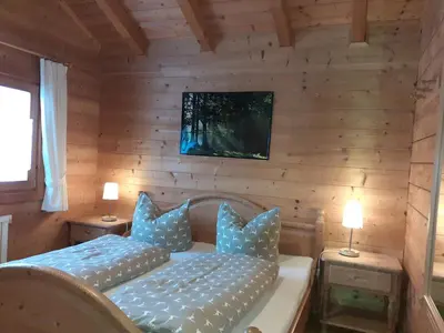 Ein Bett oder Betten in einem Zimmer der Unterkunft Blockhäuser Stamsried