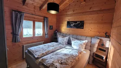 Ein Bett oder Betten in einem Zimmer der Unterkunft Blockhäuser Stamsried