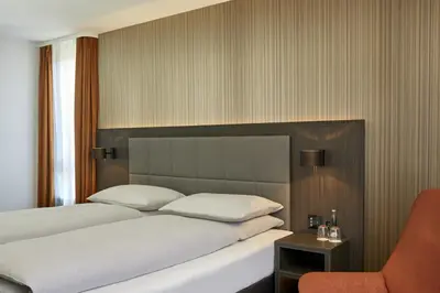 Ein Bett oder Betten in einem Zimmer der Unterkunft H4 Hotel Residenzschloss Bayreuth