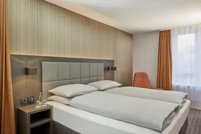 Ein Bett oder Betten in einem Zimmer der Unterkunft H4 Hotel Residenzschloss Bayreuth
