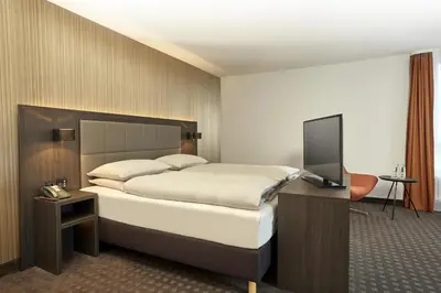 Ein Bett oder Betten in einem Zimmer der Unterkunft H4 Hotel Residenzschloss Bayreuth