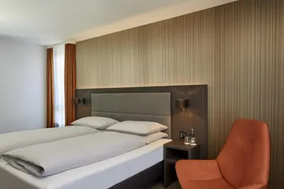 Ein Bett oder Betten in einem Zimmer der Unterkunft H4 Hotel Residenzschloss Bayreuth