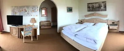 Ein Bett oder Betten in einem Zimmer der Unterkunft Hotel Bergblick