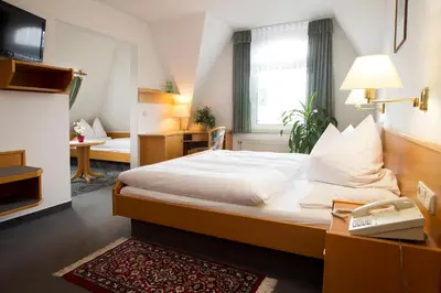 Ein Bett oder Betten in einem Zimmer der Unterkunft Hotel Heinz