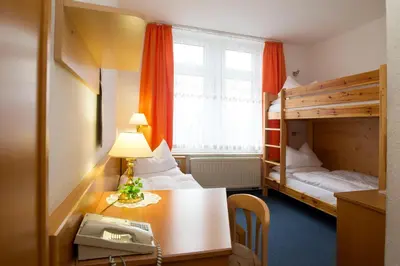 Ein Bett oder Betten in einem Zimmer der Unterkunft Hotel Heinz