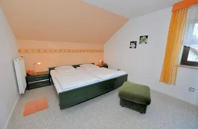 Ein Bett oder Betten in einem Zimmer der Unterkunft Ferienwohnung Brunner - Haus am See