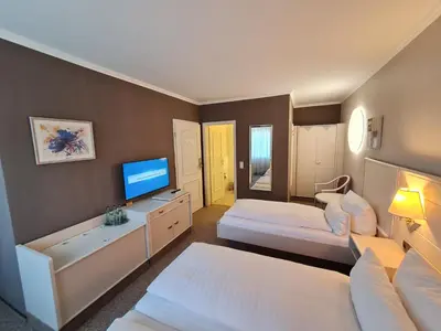 Ein Bett oder Betten in einem Zimmer der Unterkunft Ambiente Hotel garni