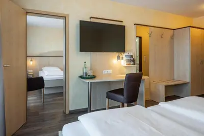 Ein Bett oder Betten in einem Zimmer der Unterkunft Hotel Wolfringmühle