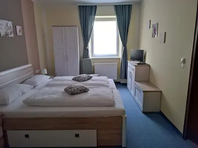 Ein Bett oder Betten in einem Zimmer der Unterkunft Garni Hotel Post