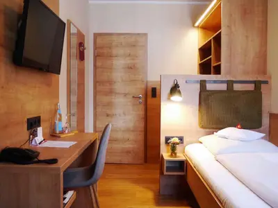 Ein Bett oder Betten in einem Zimmer der Unterkunft Da`Sporrer Hotel & Wirtshaus