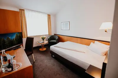 Ein Bett oder Betten in einem Zimmer der Unterkunft Sonnenhotel Hoher Hahn