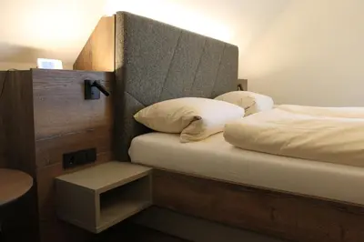 Ein Bett oder Betten in einem Zimmer der Unterkunft Landhotel Kastanienhof