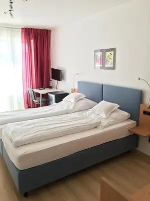 Ein Bett oder Betten in einem Zimmer der Unterkunft Hotel Bairischer Hof
