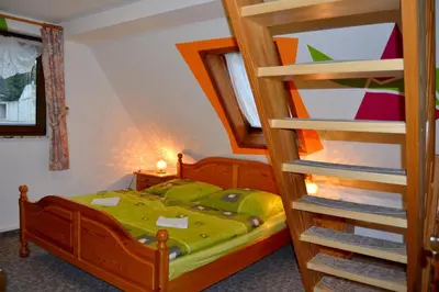 Ein Bett oder Betten in einem Zimmer der Unterkunft Landgasthof und Pension Erzgebirgsstübel
