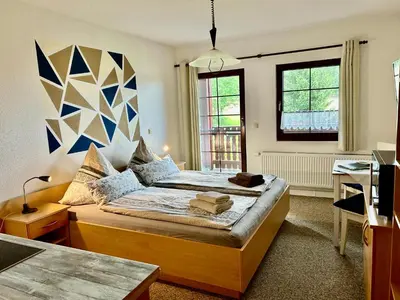 Ein Bett oder Betten in einem Zimmer der Unterkunft Pumphuts Scheune Ferienwohnungen Nr 1 - 4 beim Freizeitpark Plohn