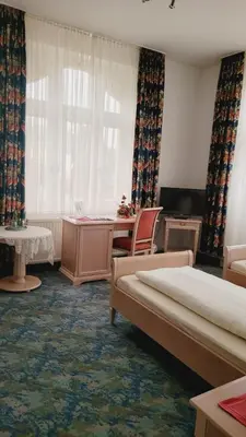 Ein Bett oder Betten in einem Zimmer der Unterkunft Pension Fürstenhof
