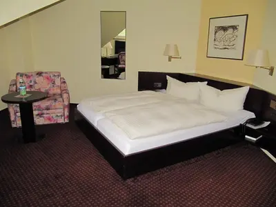 Ein Bett oder Betten in einem Zimmer der Unterkunft Hotel Wettin