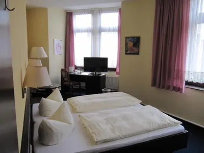Ein Bett oder Betten in einem Zimmer der Unterkunft Hotel Wettin