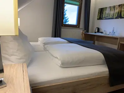 Ein Bett oder Betten in einem Zimmer der Unterkunft Hohe Tanne